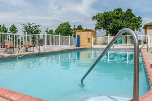 a swimming pool with a hand rail in a resort at Quality Inn Lewisport in Lewisport