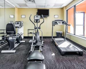 a gym with several tread machines and a flat screen tv at Comfort Inn Winchester in Winchester