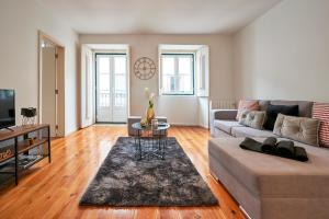 a living room with a couch and a table at Casa Portuguesa Rosa in Lisbon