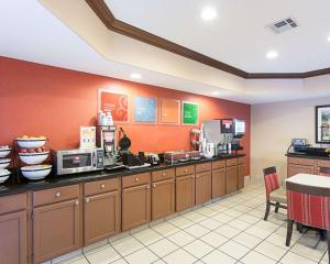 a fast food kitchen with orange walls and a counter at Comfort Inn Marrero - New Orleans West in Marrero