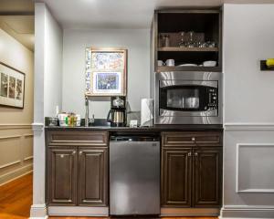 a kitchen with a microwave and a dishwasher at Bluegreen Vacations Club La Pension in New Orleans +29 photos