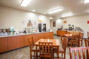 a restaurant with wooden tables and a counter with a cafeteria at Quality Inn & Suites Federal Way - Seattle in Federal Way