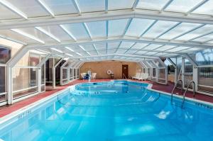 a large swimming pool with a large ceiling at Quality Inn in West Springfield