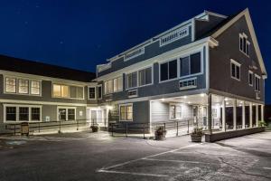 a building with a parking lot in front of it at Bluegreen Vacations The Breakers, an Ascend Resort in Dennis Port