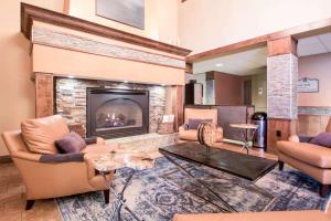 a living room with chairs and a fireplace at Bluegreen Vacations Odyssey Dells Resort in Wisconsin Dells