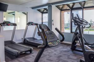 a gym with two treadmills and two ellipticals at Quality Inn & Suites Clackamas - Portland in Clackamas