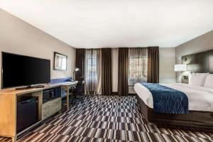 a hotel room with a bed and a flat screen tv at Comfort Inn Memphis Airport West in Memphis