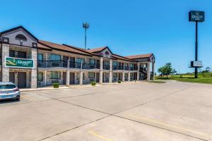 a building with a car parked in a parking lot at Quality Inn I-10 East near Frost Bank Center in San Antonio