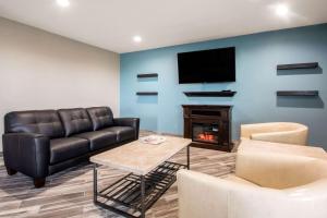 a living room with a couch and a fireplace at Quality Inn Madison West Near University Area in Madison