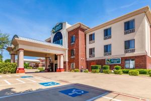 a hotel with a parking lot in front of it at Quality Inn & Suites in Lampasas