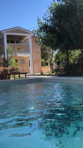 a swimming pool in front of a house at Wellness House Oliva with heated salt water Pool, Sauna & Jakuzzi in Labin