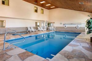 a swimming pool with blue water in a house at Quality Inn & Suites Albuquerque North near Balloon Fiesta Park in Albuquerque