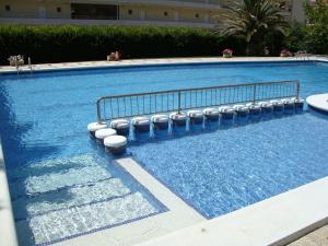 a large swimming pool with blue water at Payet Apartments in L'Estartit