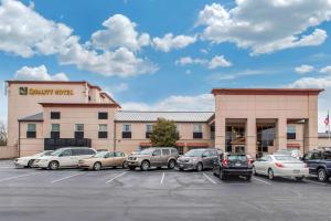 a car dealership with cars parked in a parking lot at Quality Hotel Conference Center Cincinnati Blue Ash in Blue Ash