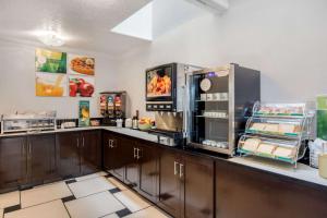 a kitchen with a counter with a refrigerator at Quality Inn & Suites Albuquerque North near Balloon Fiesta Park in Albuquerque