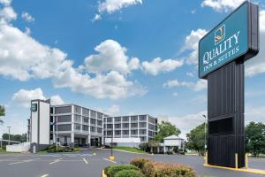 a sign for a hotel in front of a building at Quality Inn and Conference Center in Richmond