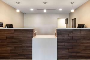 a lobby with a white counter and wooden floors at Comfort Suites Grove City - Columbus South in Grove City