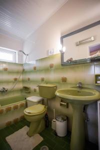 a bathroom with a yellow toilet and a sink at Natural Beauty Spot in Áno Garoúna