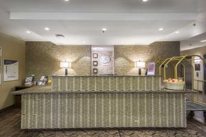 a lobby of a hotel with a reception counter at Comfort Suites in Saskatoon +39 photos