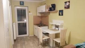 a small kitchen with a small table and chairs at Pension Dreger in Freimersheim