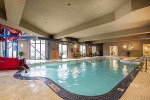 a large swimming pool in a hotel room at Comfort Suites Saskatoon in Saskatoon