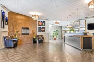 a lobby with chairs and a bar in a building at Travelodge by Wyndham Trois-Rivieres in Trois-Rivières