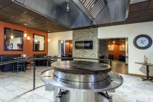 a large room with a large wine barrel on a table at Econo Lodge Sudbury in Sudbury