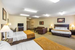 a hotel room with two beds and a couch at Comfort Suites Summit County in Dillon