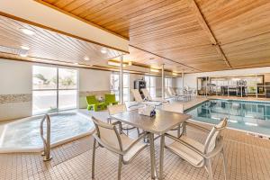 a house with a pool and a table and chairs at Quality Inn & Suites University Fort Collins in Fort Collins