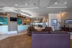a lobby with a couch and chairs in a room at Quality Inn & Suites Yellowknife in Yellowknife