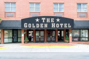 a building with a sign for the golden hotel at The Golden Hotel, Ascend Hotel Collection in Golden