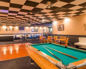 a pool table in a room with tables and chairs at Clarion Inn and Events Center Pueblo North in Pueblo