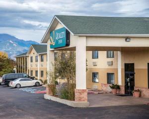 a hotel inn with a car parked in a parking lot at Quality Inn Airport in Colorado Springs