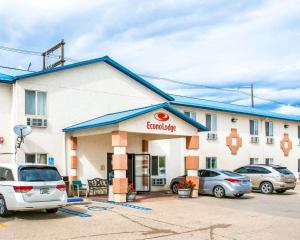 a gas station with cars parked in a parking lot at Econo Lodge in Canon City