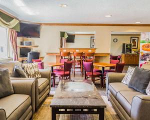 a living room with couches and a bar at Quality Inn & Suites Golden - Denver West in Lakewood