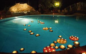 a pool filled with lots of lights and balloons at Relais Madonna di Campagna in Bastia Umbra