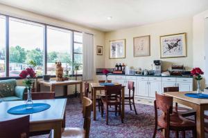 a kitchen and dining room with tables and chairs at Rodeway Inn & Suites Colorado Springs in Colorado Springs