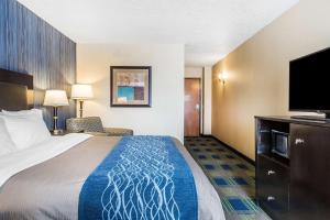 a hotel room with a bed and a flat screen tv at Comfort Inn & Suites Meriden East in Meriden +39 photos