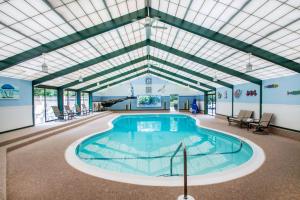 a swimming pool in a building with a glass ceiling at Quality Inn Old Saybrook - Westbrook in Old Saybrook