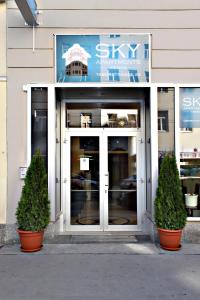 a store entrance with two plants in front of it at Sky Apartments Vienna in Vienna