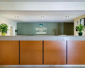 a hotel lobby with a reception desk with a sign at Quality Inn in Newark