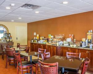 a restaurant with tables and chairs and a counter at Quality Inn Waterbury East in Waterbury
