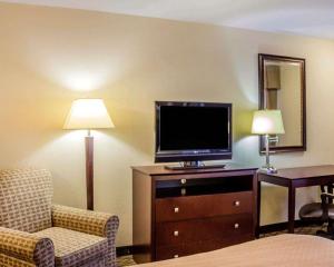 a hotel room with a tv and a couch and a chair at Quality Inn Waterbury East in Waterbury +20 photos