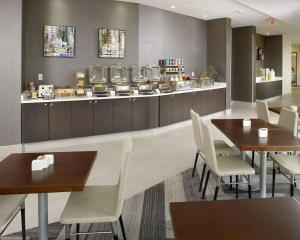 a restaurant with tables and chairs and a counter at Cambria Hotel Washington, DC Convention Center in Washington