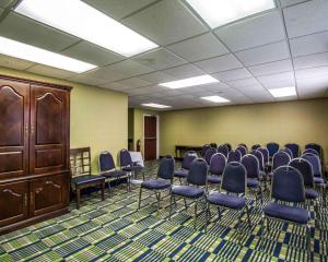 a conference room with chairs and a wooden cabinet at Comfort Inn & Suites Lantana - West Palm Beach South in Lantana +27 photos