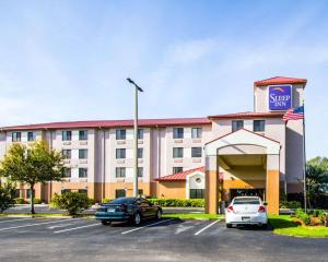 a hotel with cars parked in a parking lot at Sleep Inn Fort Pierce I-95 in Fort Pierce