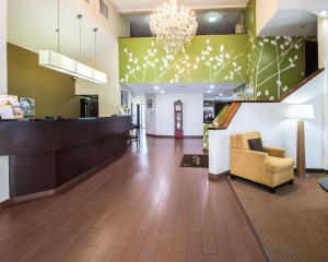 a lobby of a hospital with a couch and a chandelier at Sleep Inn Fort Pierce I-95 in Fort Pierce