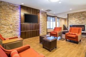 a living room filled with furniture and a tv at Comfort Inn at the parks in Orlando