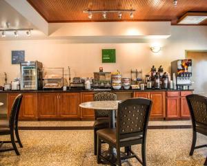 a kitchen with a table and chairs and a counter at Comfort Inn & Suites Panama City - St Andrew in Panama City