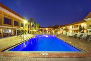a swimming pool in a hotel at night at Quality Inn and Suites Conference Center in New Port Richey
